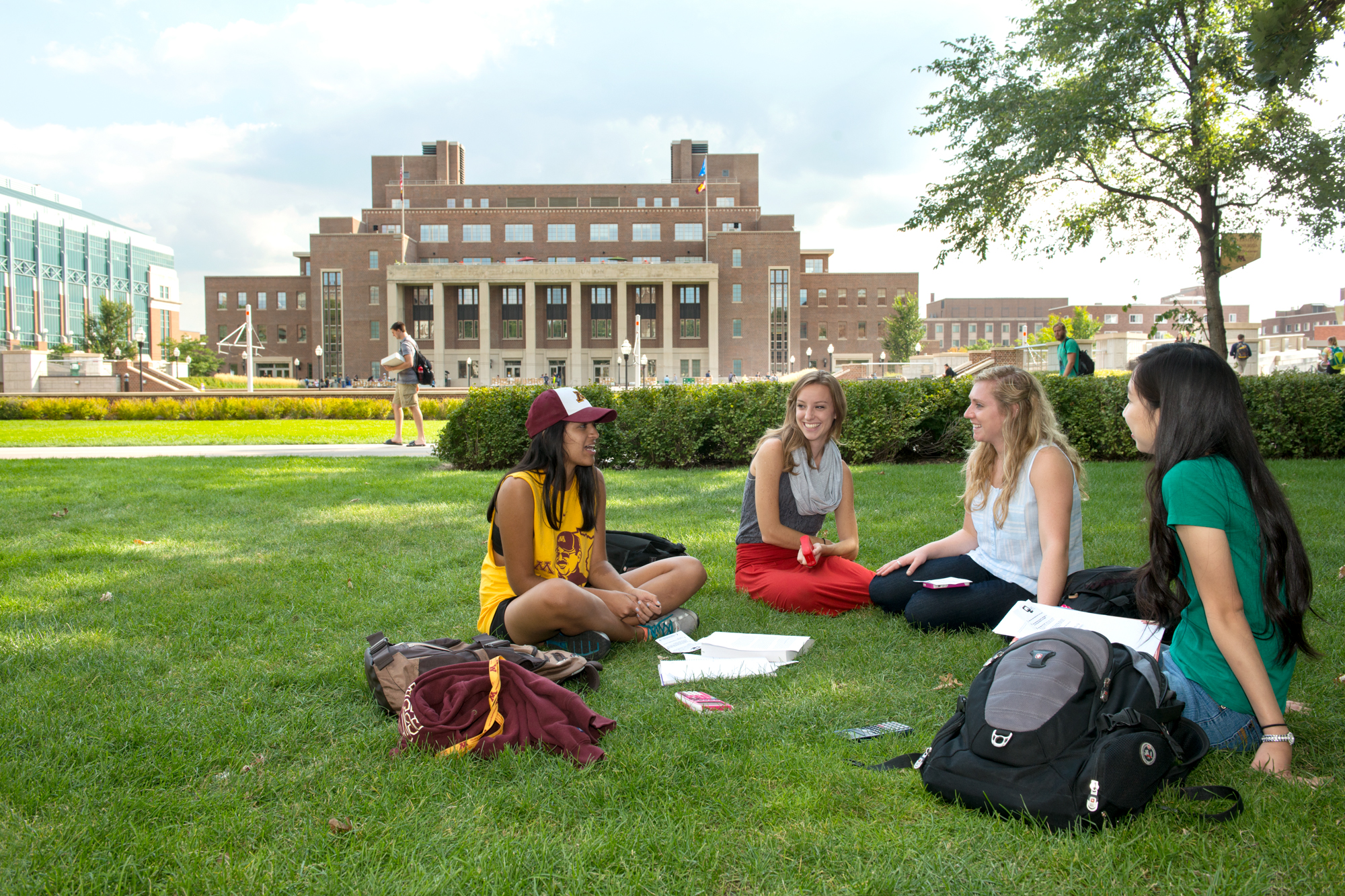 Students studying on the grass on campus