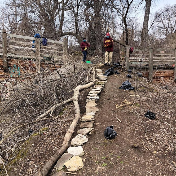 Students in the group S.O.I.L. (Student Objectives in Landscape) volunteer at Father Hennepin Park on the Mississippi Riverfront.