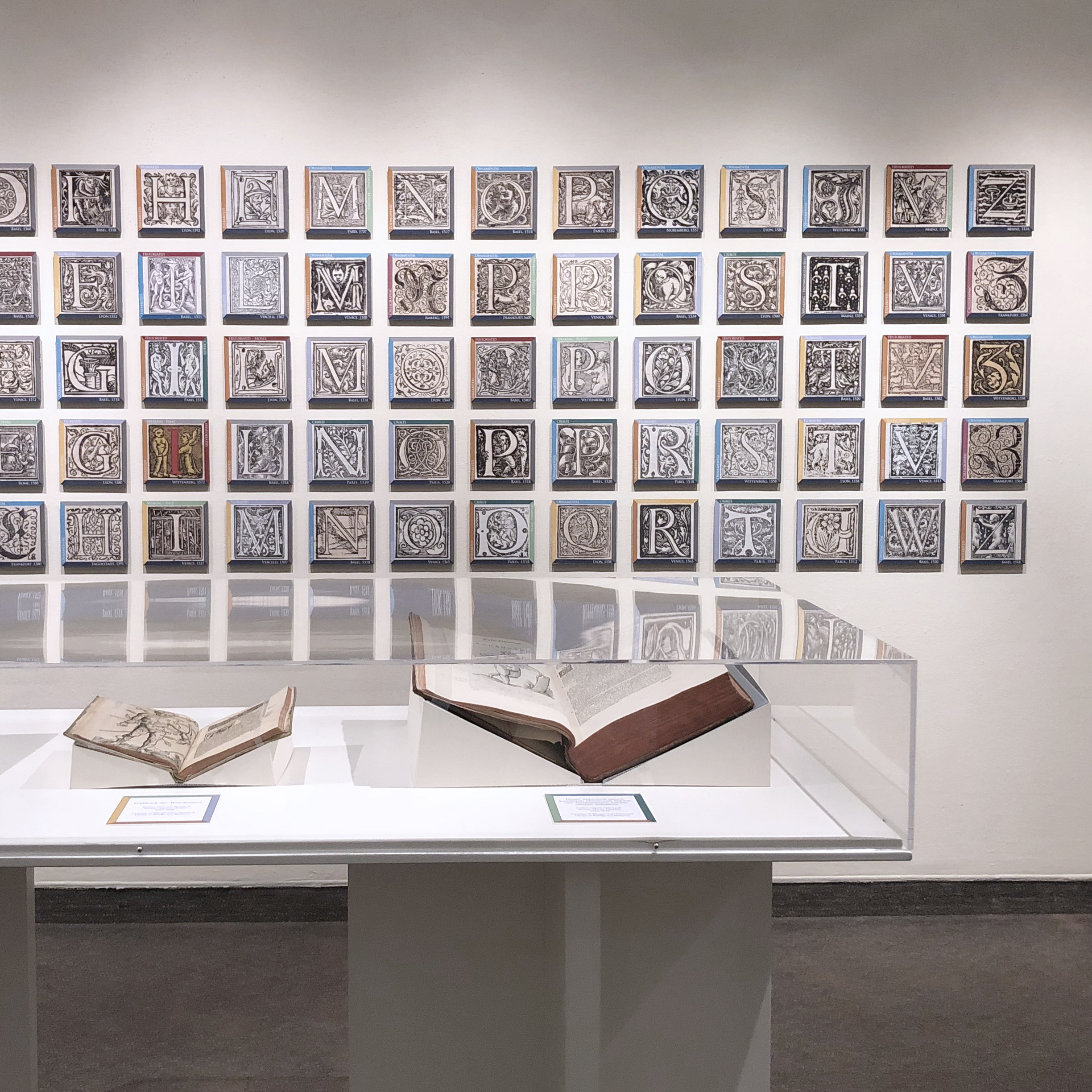 Initial Impressions Exhibition letters and open books