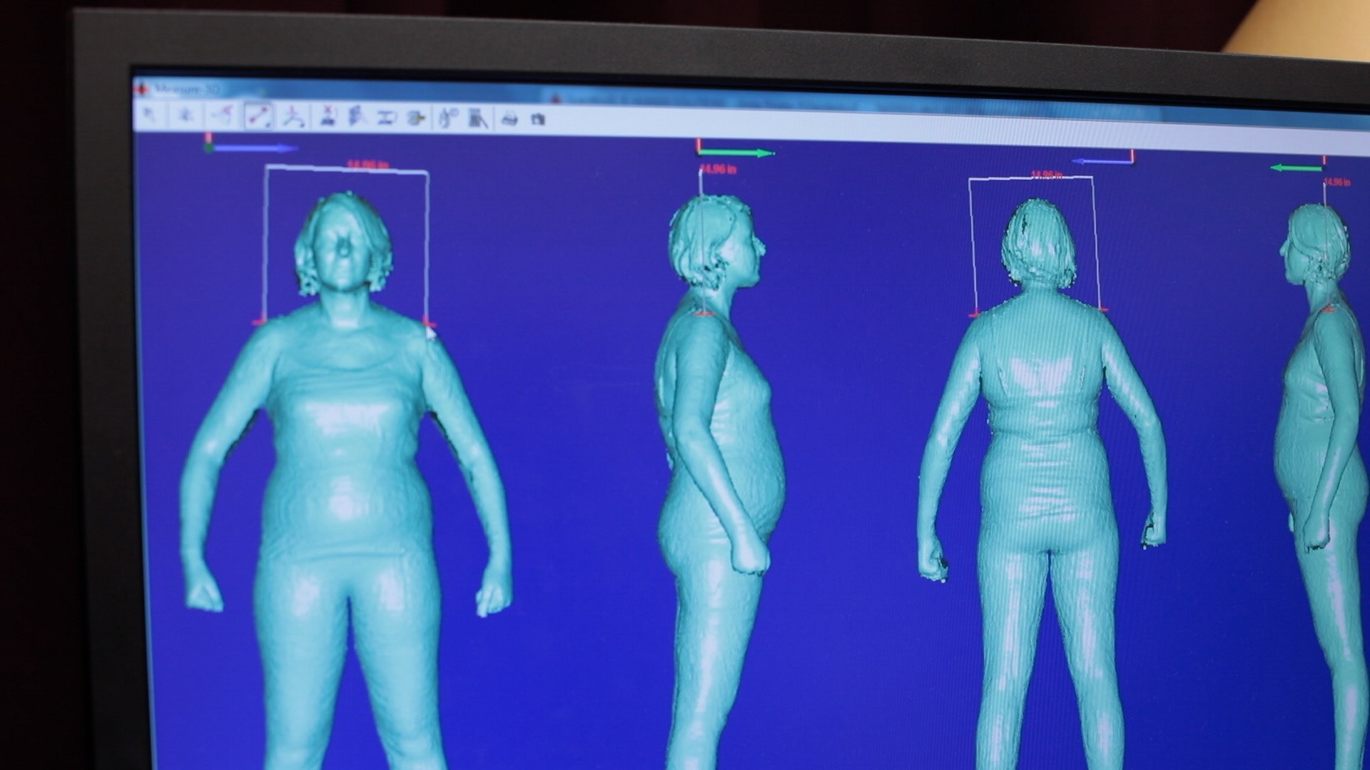 A computer monitor displaying software analyzing images of the human form from several angles