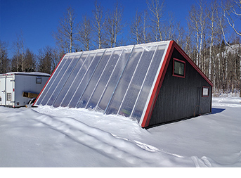 Winter greenhouse in a snowy landscape