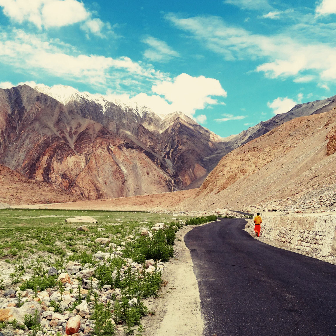 Ladakh: A Spirit of Place image of person walking along a road with mountains