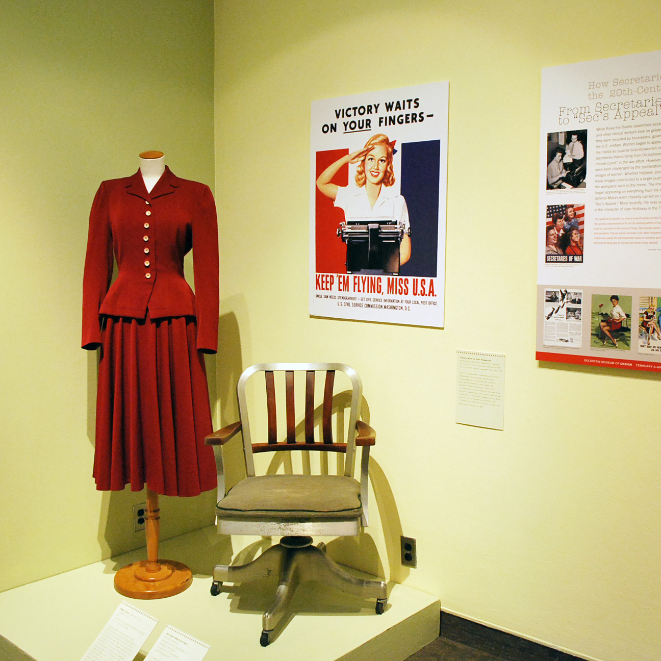 How Secretaries Changed the 20th-Century office: Design, Image, and Culture exhibition with posters, clothing, and furniture on display