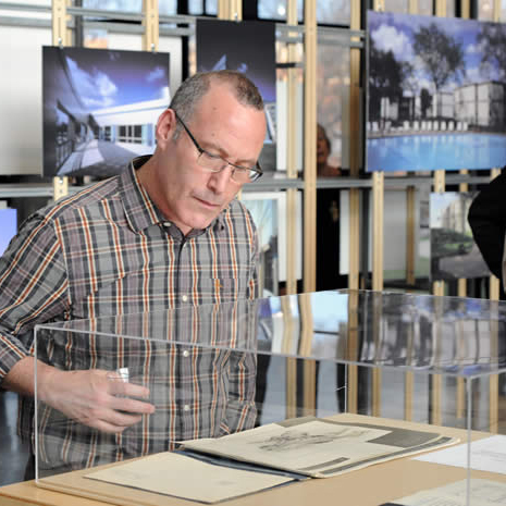 Leonard Parker: An Architect's Architect exhibition with a person reading documents on display