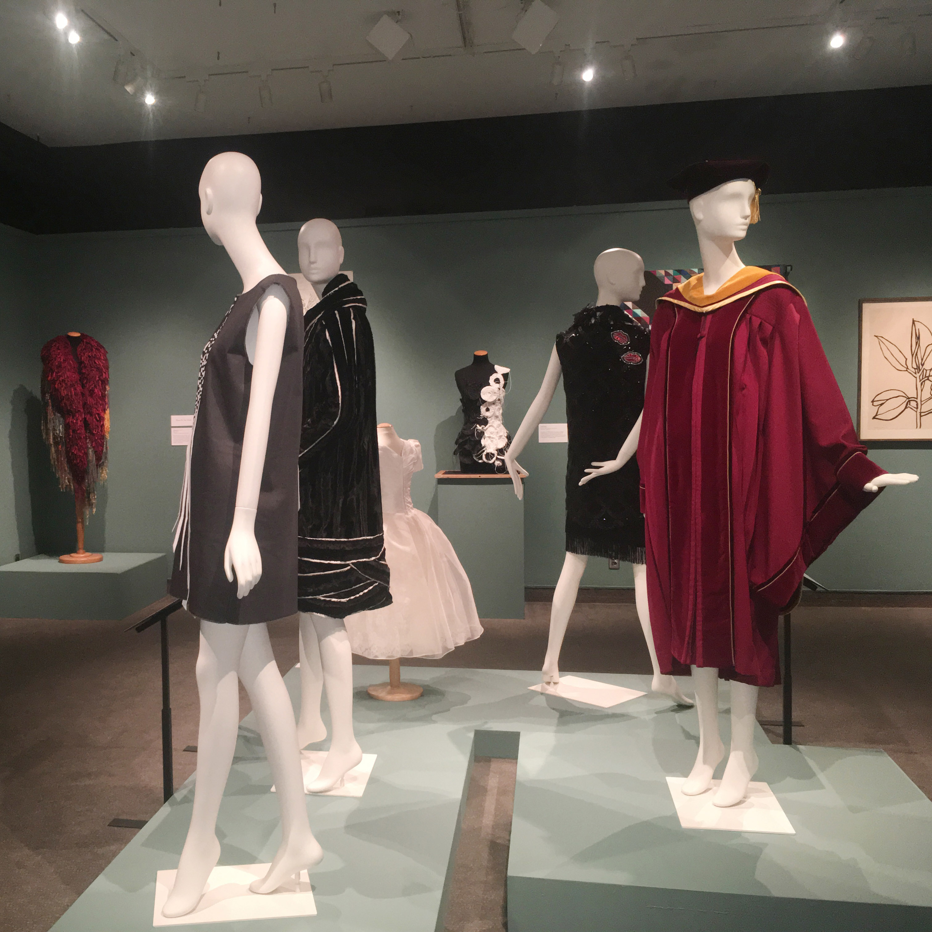 DHA 100 years of graduate education exhibition clothing on display in gallery