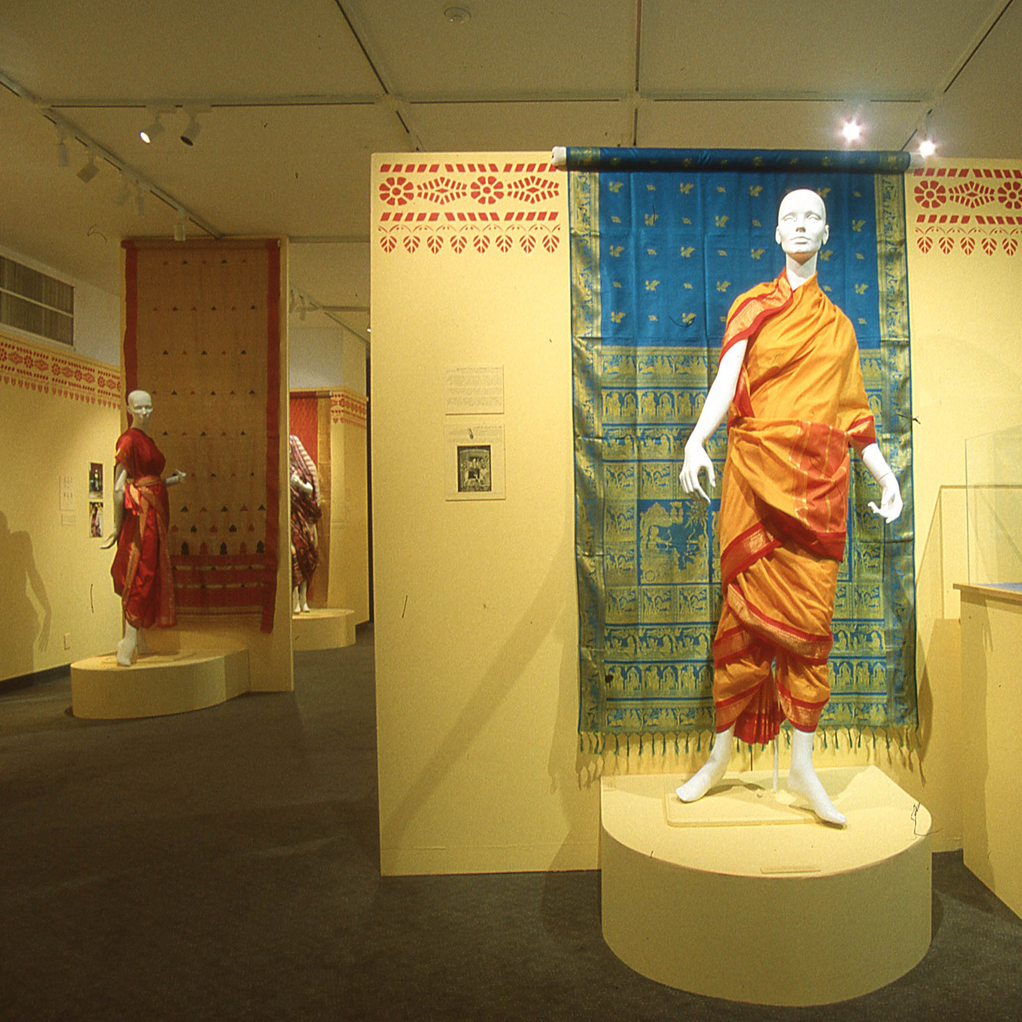 The Indian Sari: Draping Bodies, Revealing Lives Saris on display on walls and mannequins