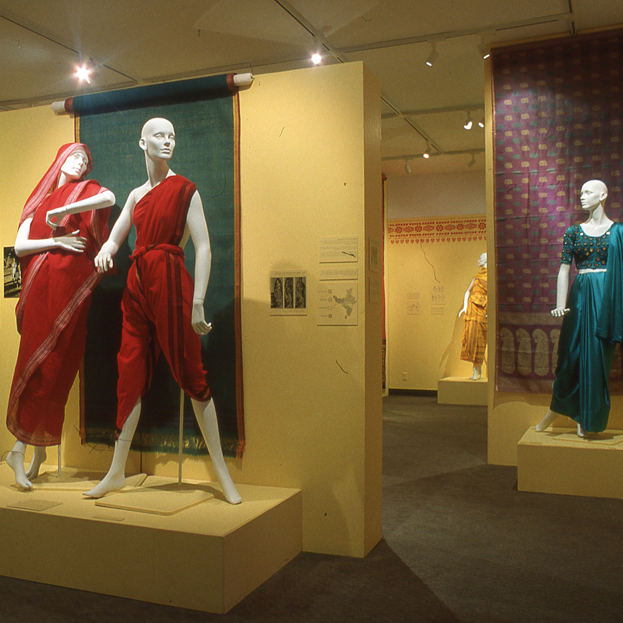 The Indian Sari: Draping Bodies, Revealing Lives Saris on display on walls and mannequins