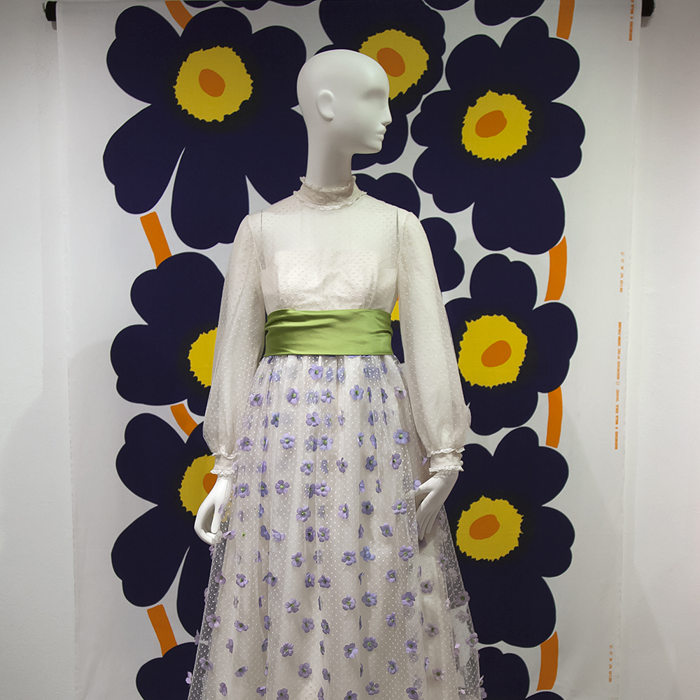 Demonstration Garden: Designing Flowers exhibition dress on mannequin in front of Marrimekko scarf