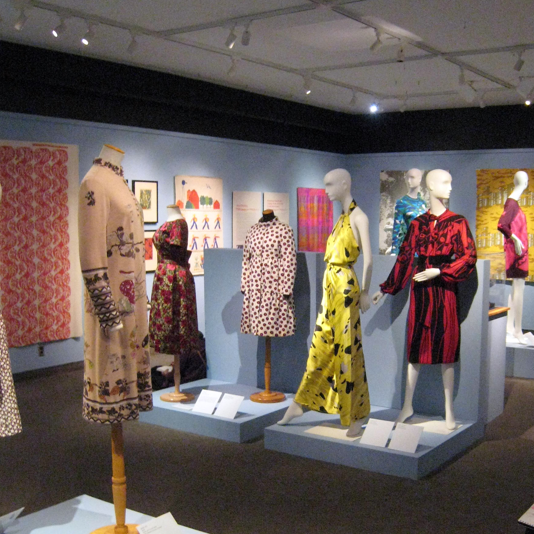 Printed Textiles Pattern Stories exhibition with patterns on display on the wall and on mannequins
