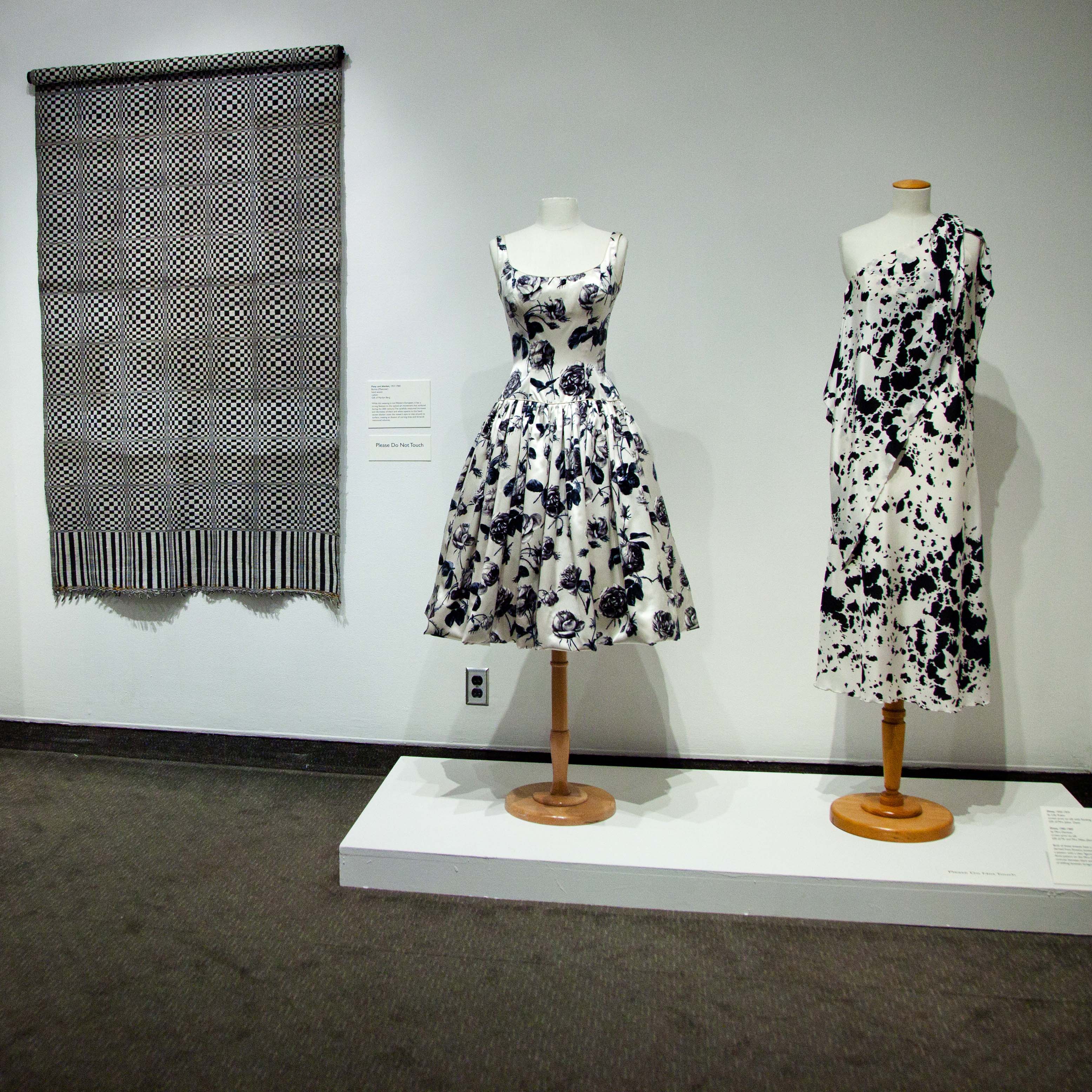 Polarities: Black and White in Design dresses and a wall hanging on display