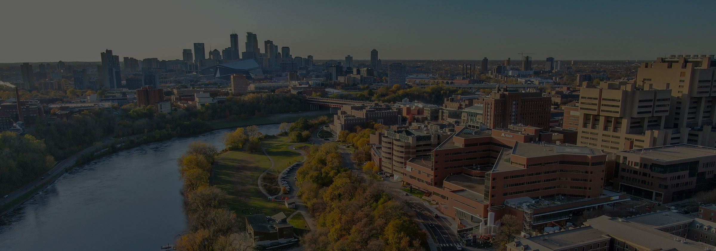 Campus with the Minneapolis skyline in the background and river gray overlay