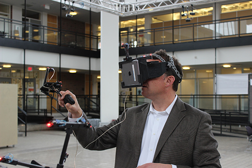 Person wearing a virtual reality device in a building courtyard