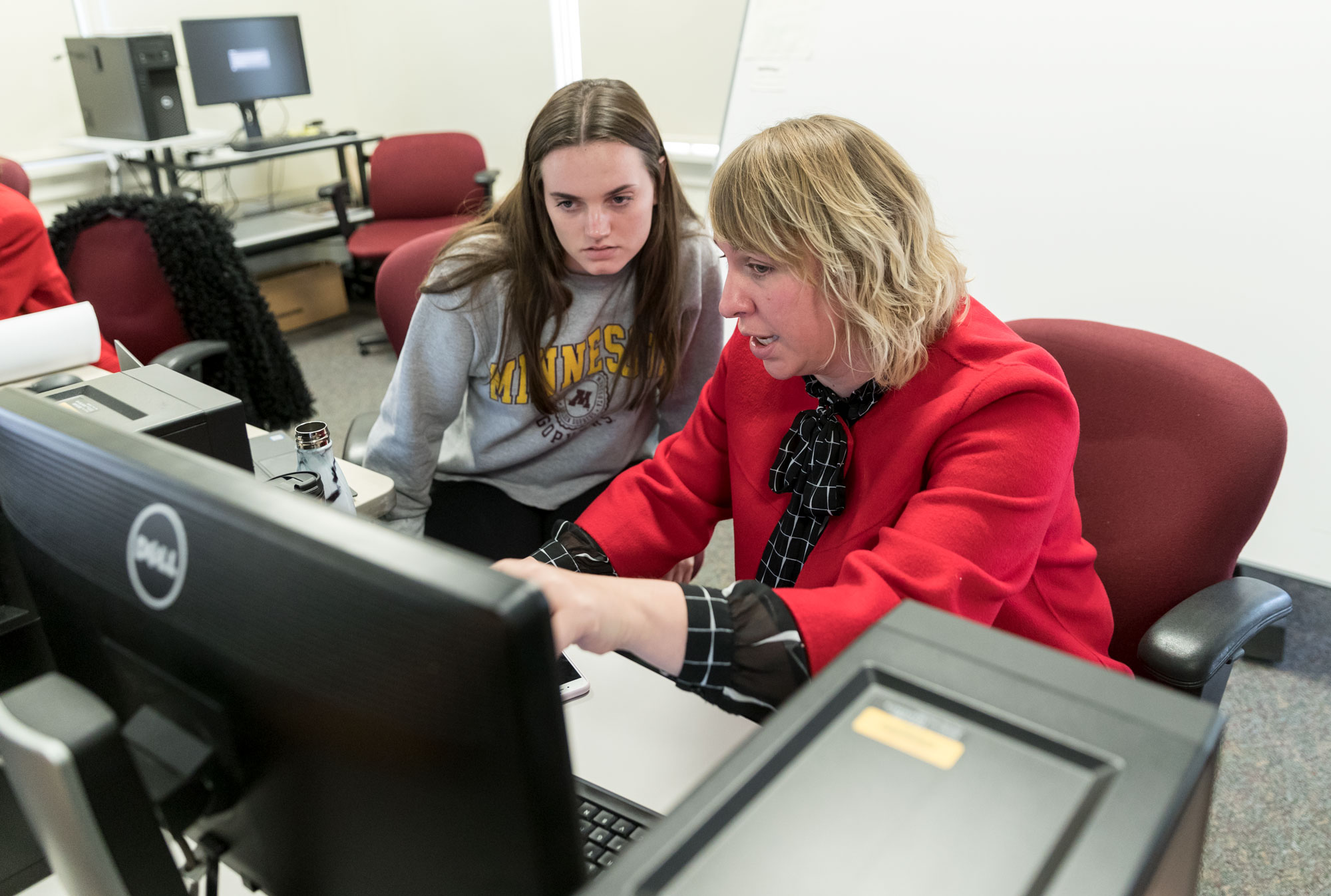 Professor Linsey Griffen working with an Apparel Design student in the computer lab
