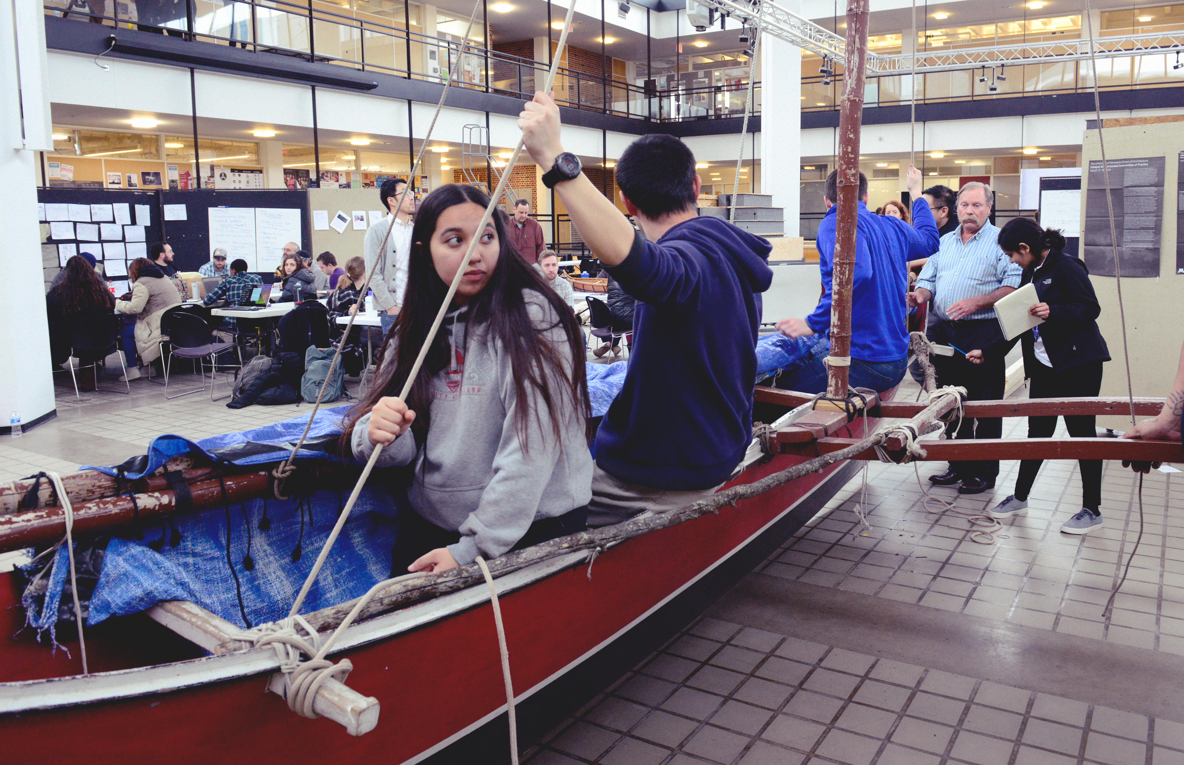 Students sitting in canoe.