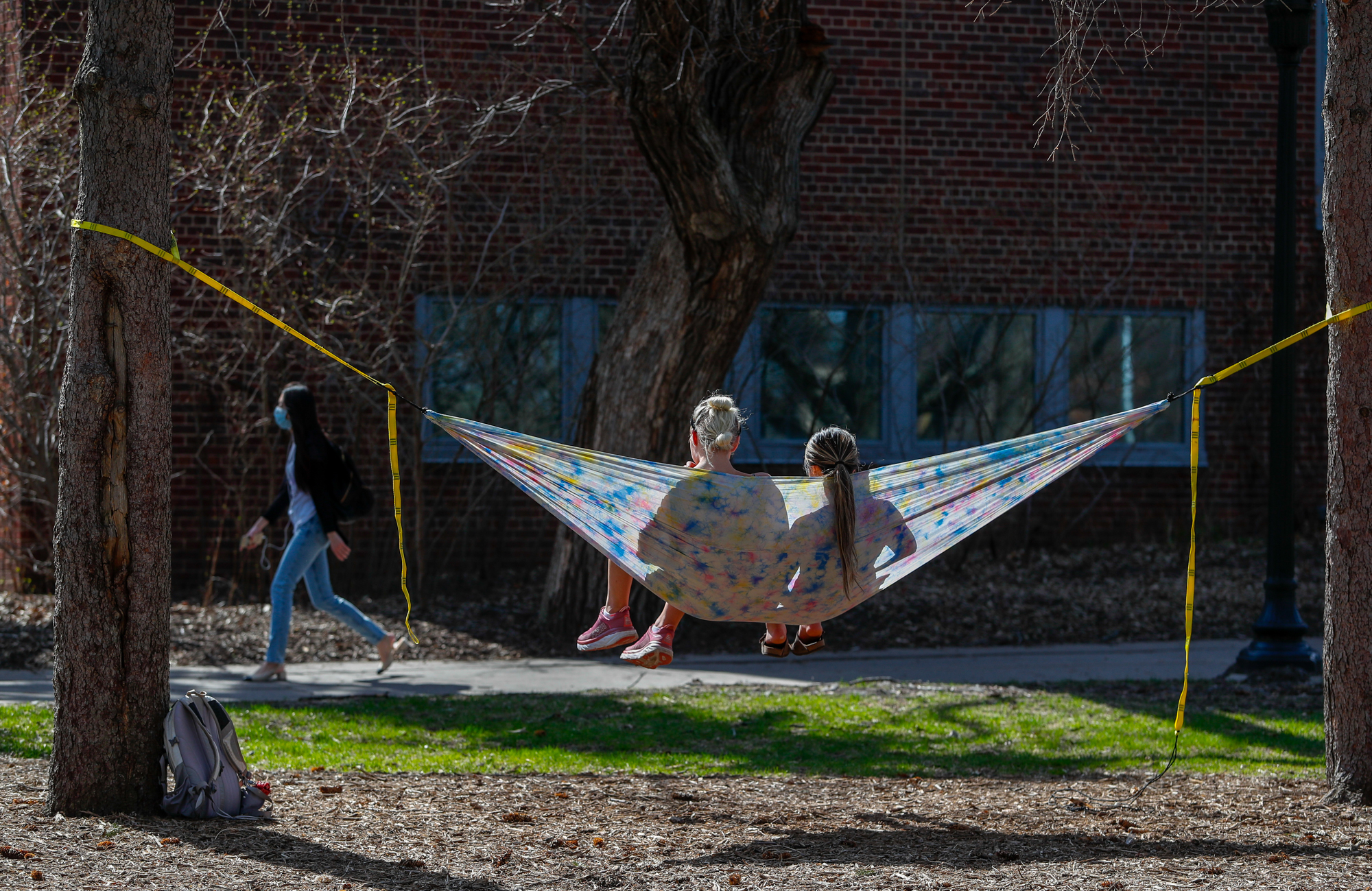 Students on campus in a hammock