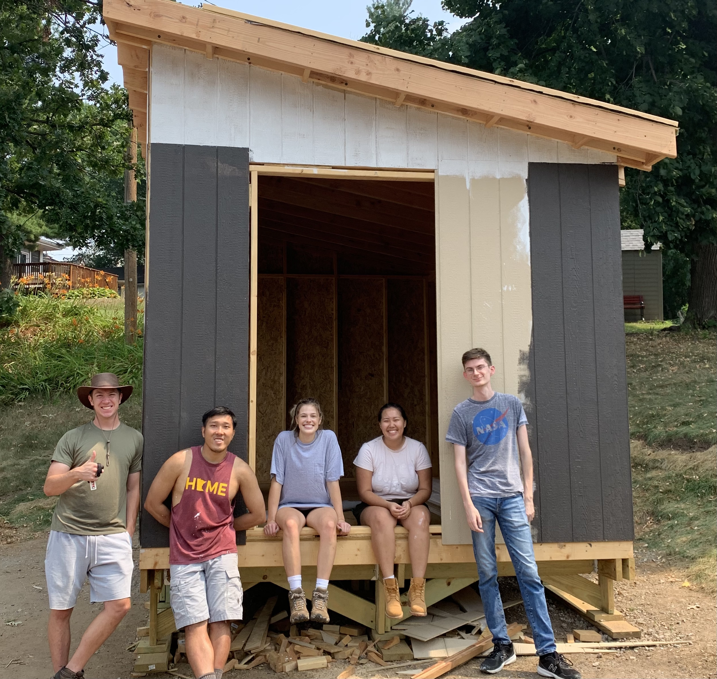 Students in AIAS Freedom by Design stand in front of the tool shed they built.
