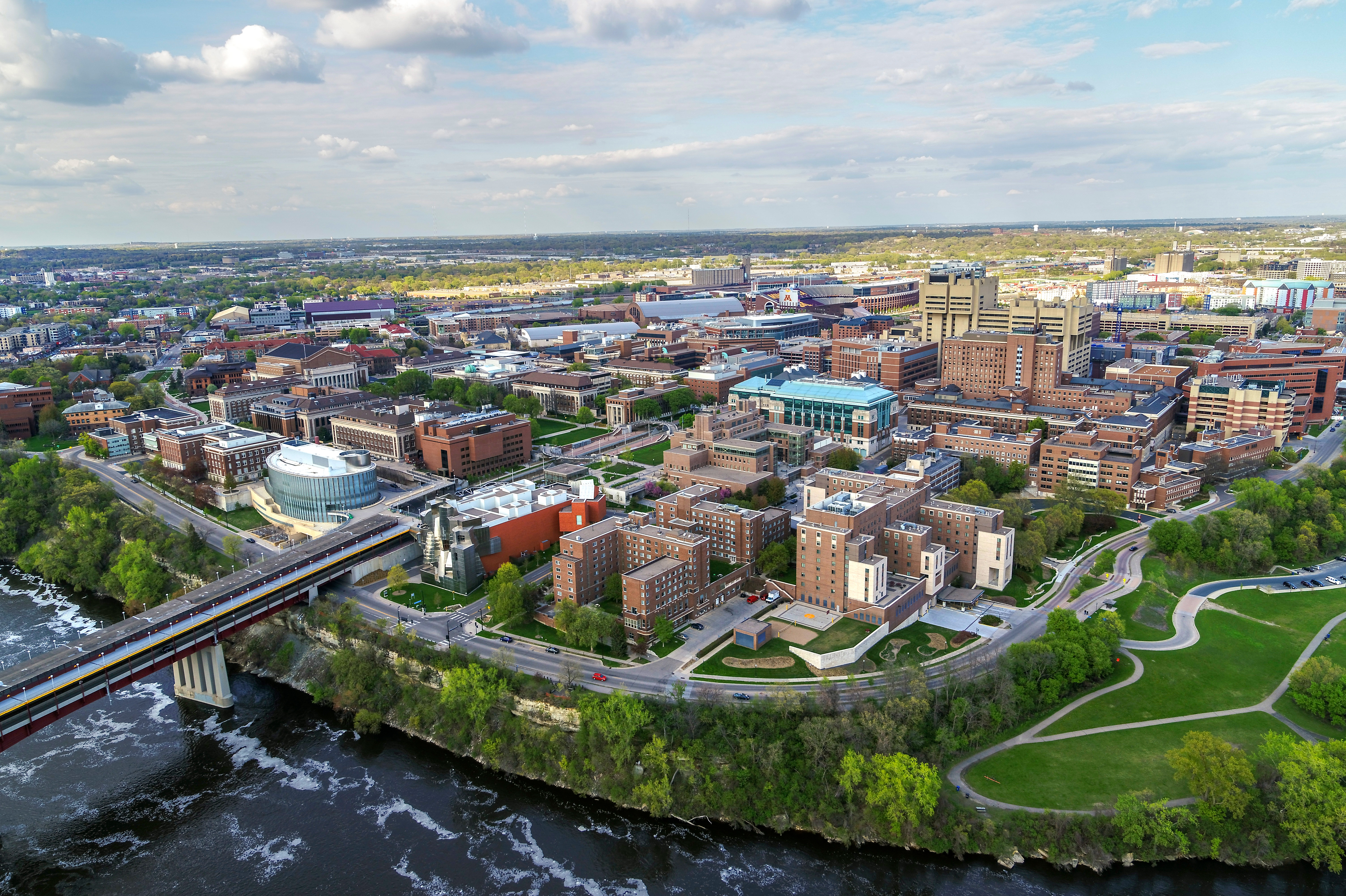 Aerial view of East Bank looking Northeast showing Washington Avenue bridge going over Mississippi River with campus sprawling North and East.