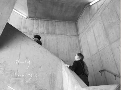 Two people walking up a staircase in Rapson Hall.