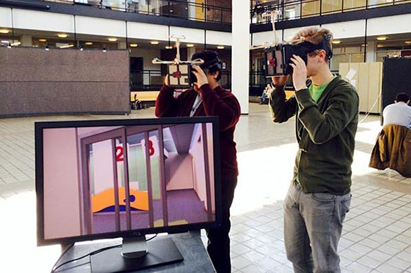 Two students use VR headsets in the Rapson Courtyard.