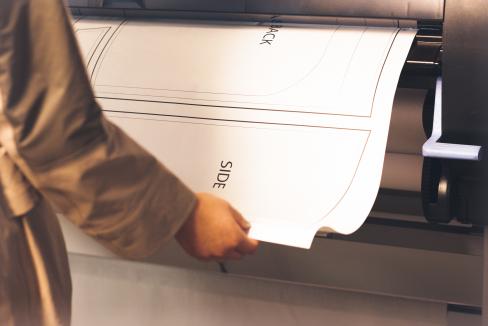 Student printing work on oversize printer plotter
