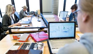 Students working on laptops in Interior Design Studio.