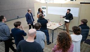 Student presenting project to group in Rapson Hall.