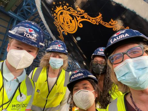 Alumna Laura Sanden Cabo and her team at the bow of a Disney Wish Cruise Ship.