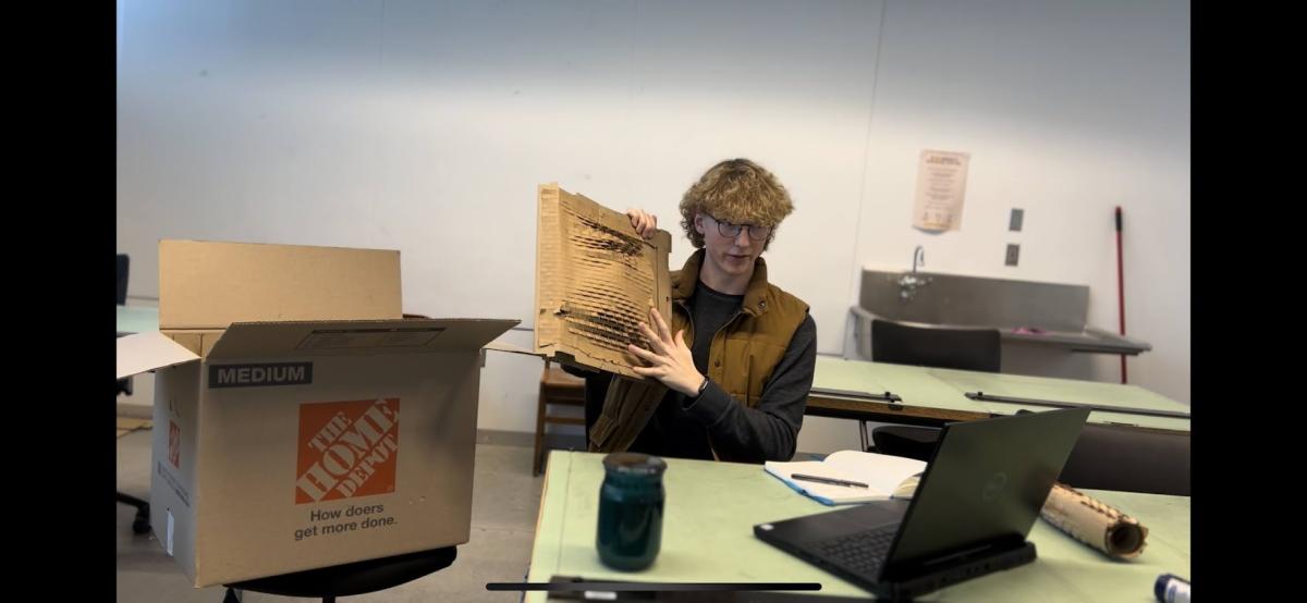 Jack Schultz works on his fragile packaging prototype.