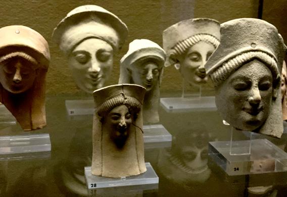 Ancient stone masks on display in a museum in Sicily, Italy