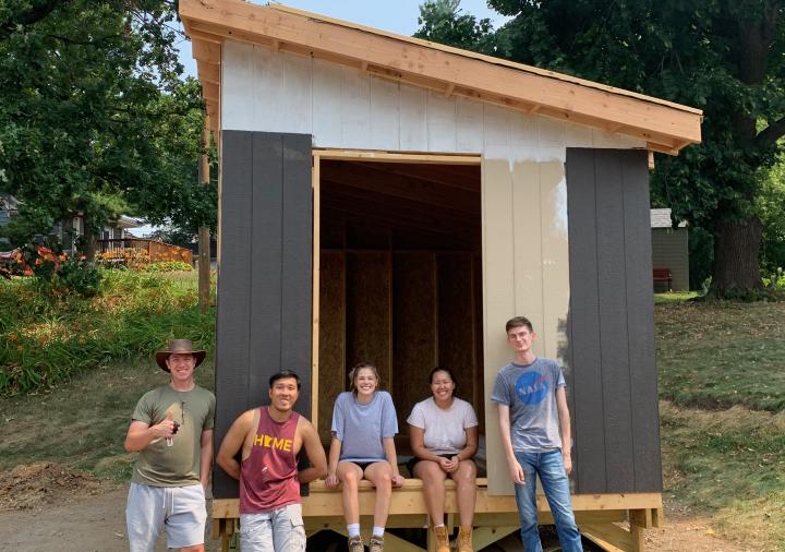 Students from AIAS Freedom by Design pose in front of the Settled tool shed.